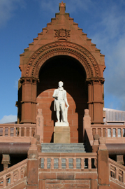 White statue of Roberts Burns standing at the Burns Monument Centre in Kilmarnock