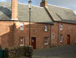 Red sandstone buildings that are now the Burns House Museum