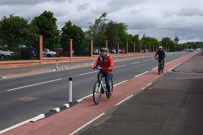 Two people cycling on the improved cycle lane at Grassyards Road, Kilmarnock