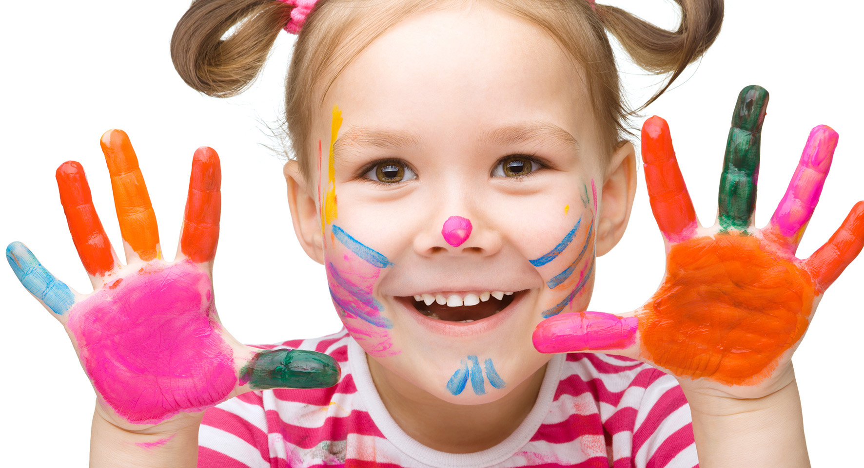 Young child smiling with face and hands painted