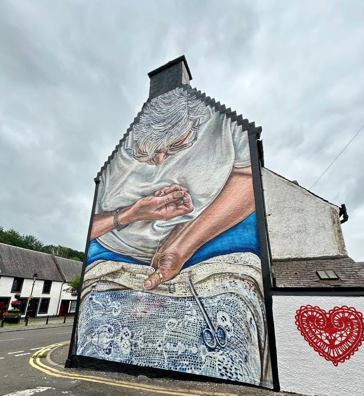 Mural of a hand darner sitting on a stool