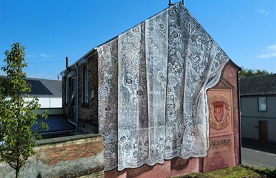 Lace and town crest mural in Newmilns