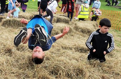 Children playing in the hay at Playday