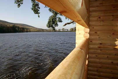 Wooden wildlife hide - looking out a narrow window across Glenbuck Loch - the start of the River Ayr Way