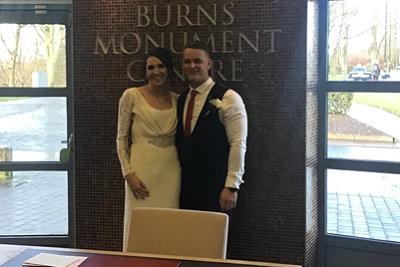 Bride and groom smiling at the Burns Monument Centre