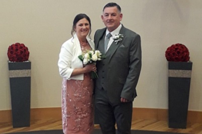 Bride and groom smiling, at the Burns Monument Centre