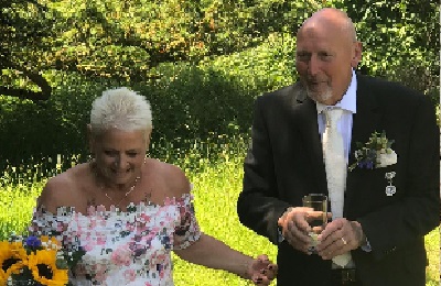 Bride and groom smiling outdoors